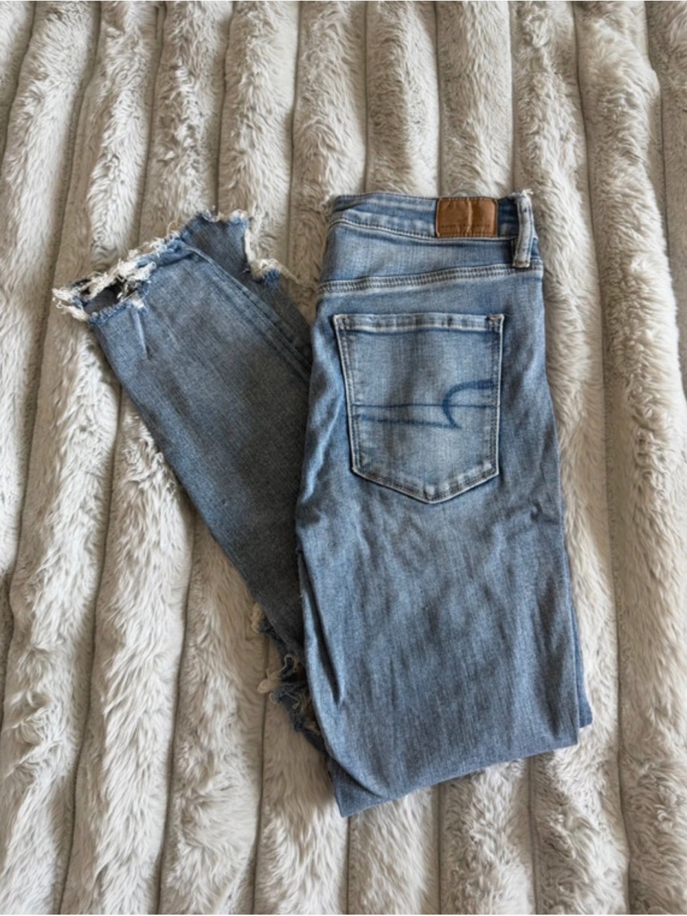 American Eagle Outfitters Light Blue Skinny Jeans with Distressed Hem